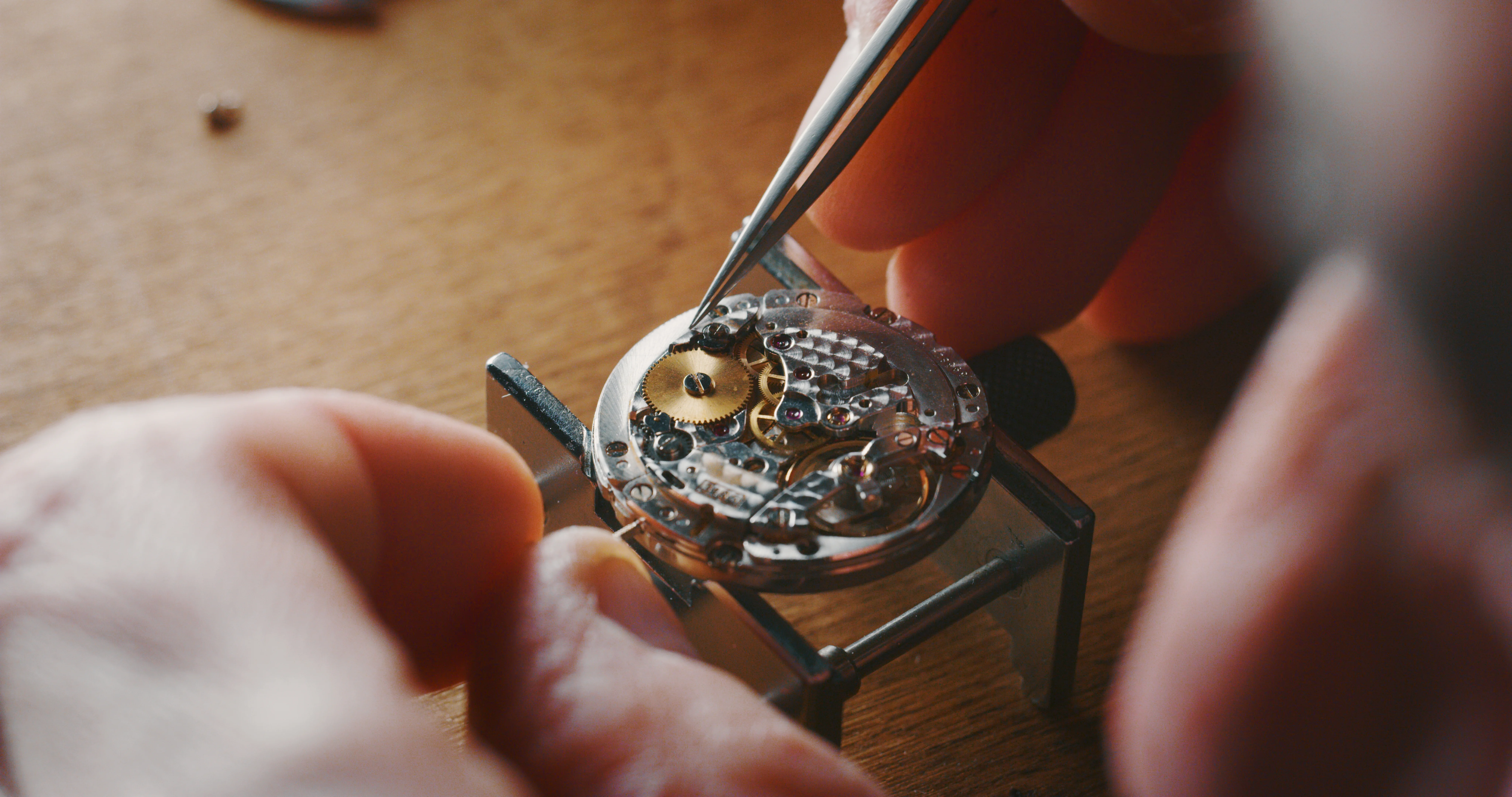 Watchmaker examining a movement
